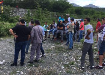 Gente mirando hombre muerto